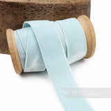Petershams Millinery Supplies light blue 23mm elastic stretch velvet ribbon on a wooden spool
