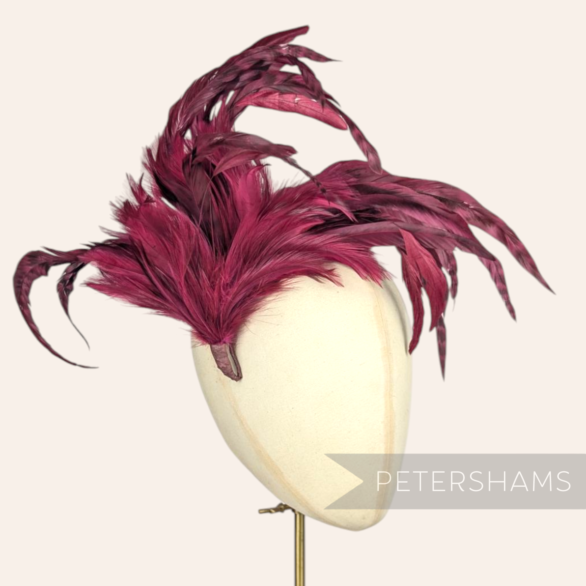 Petershams Millinery Supplies extra large deep magenta coque and hackle feather hat mount on a millinery head form