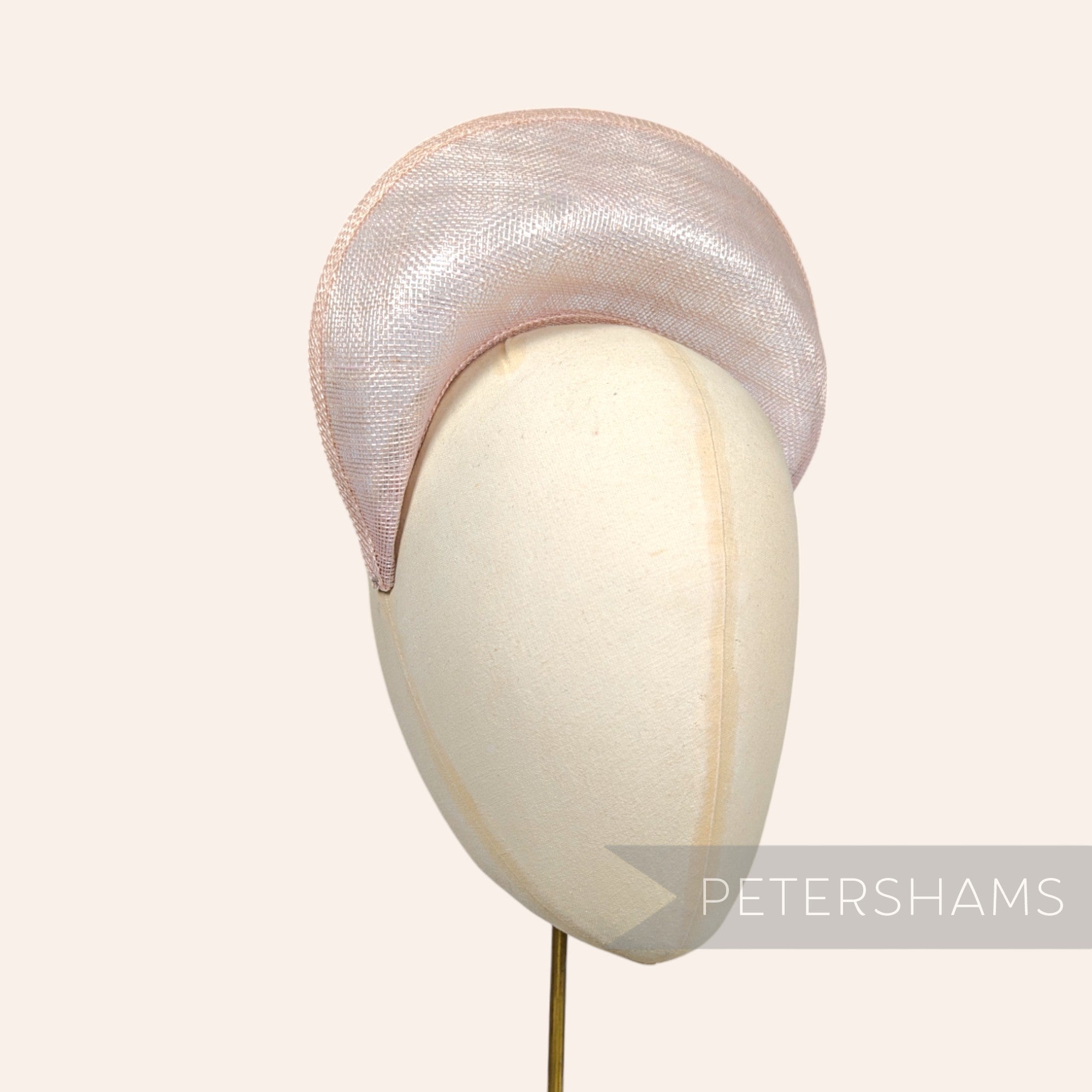 Petershams Millinery Supplies metallic lurex sinamay halo crown fascinator hat base in a subtle shimmering pink tone.
