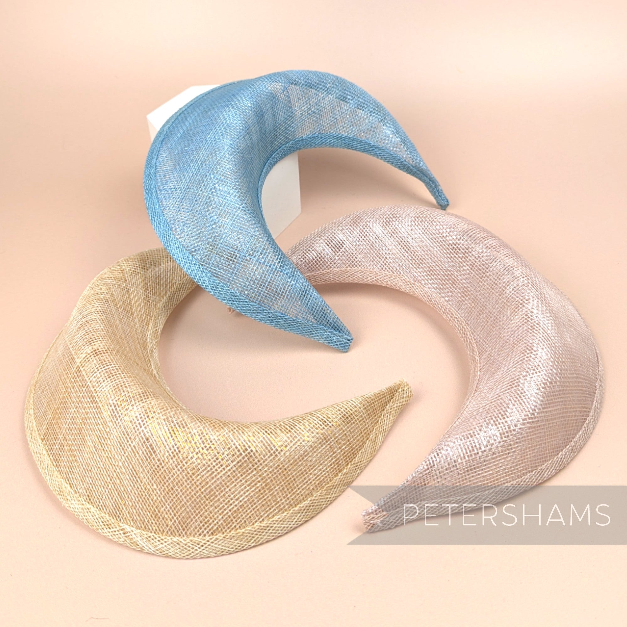Petershams Millinery Supplies metallic lurex sinamay halo crown fascinator bases in blue, gold, and rose pink.