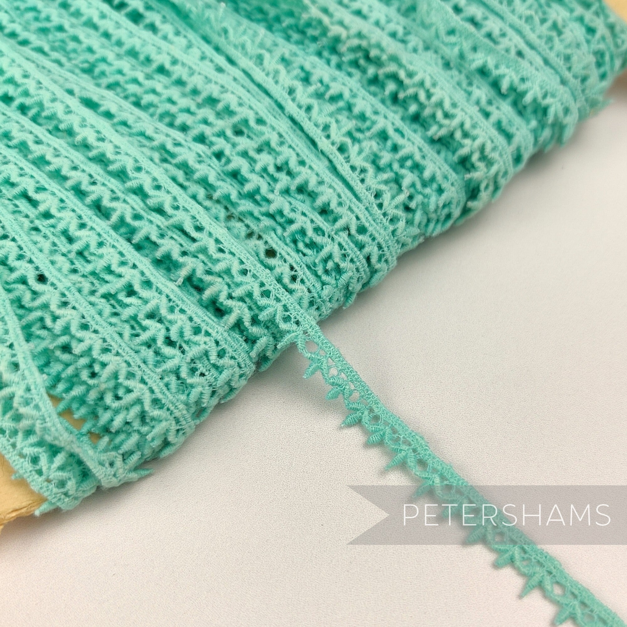 Petershams Millinery Supplies vintage 1950s English mint green cotton guipure lace trim with a teeny leafy design