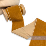 Petershams Millinery Supplies 50mm wide warm rust single-sided French velvet ribbon on a wooden spool