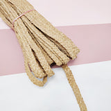 Petershams Millinery Supplies 20mm vintage natural raffia braid for hat making, coiled in a bundle.