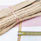 Petershams Millinery Supplies 20mm wide natural raffia braid for hat making, shown with a measuring tape.