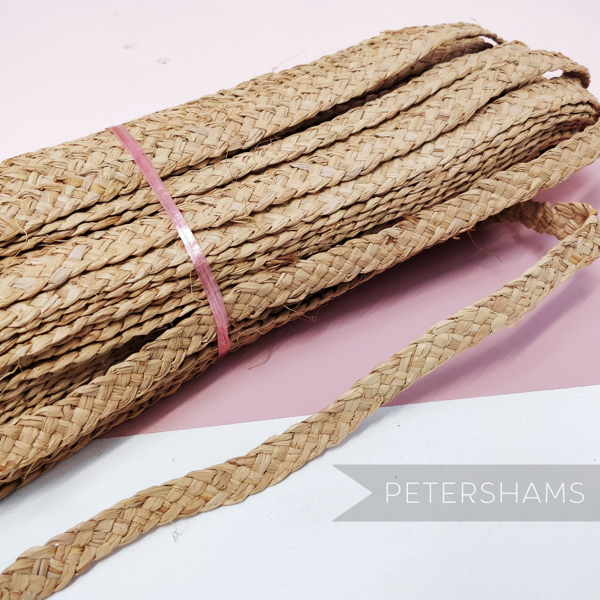 Petershams Millinery Supplies vintage 20mm natural raffia braid for hat making, coiled with a loose end.