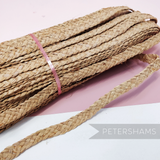 Petershams Millinery Supplies vintage 20mm natural raffia braid for hat making, coiled with a loose end.