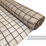 Petershams Millinery Supplies natural sinamay abaca fabric with a brown wool yarn square check pattern on a roll.