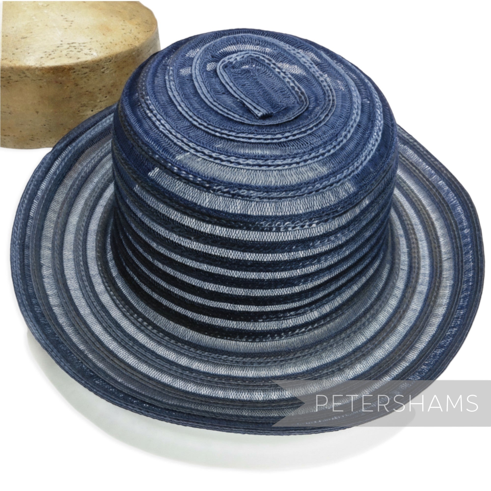 Petershams Millinery Supplies navy blue swirled crinoline and polybraid capeline hat body with an upturned brim.