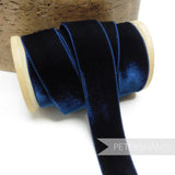 Petershams Millinery Supplies 23mm navy blue elastic velvet ribbon on a wooden spool for millinery and craft projects.