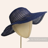 Petershams Millinery Supplies navy blue scalloped crinoline and visca braid capeline hat body on a millinery head.