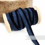 Petershams Millinery Supplies navy blue 5mm velvet insertion piping cord on a wooden spool for millinery and sewing