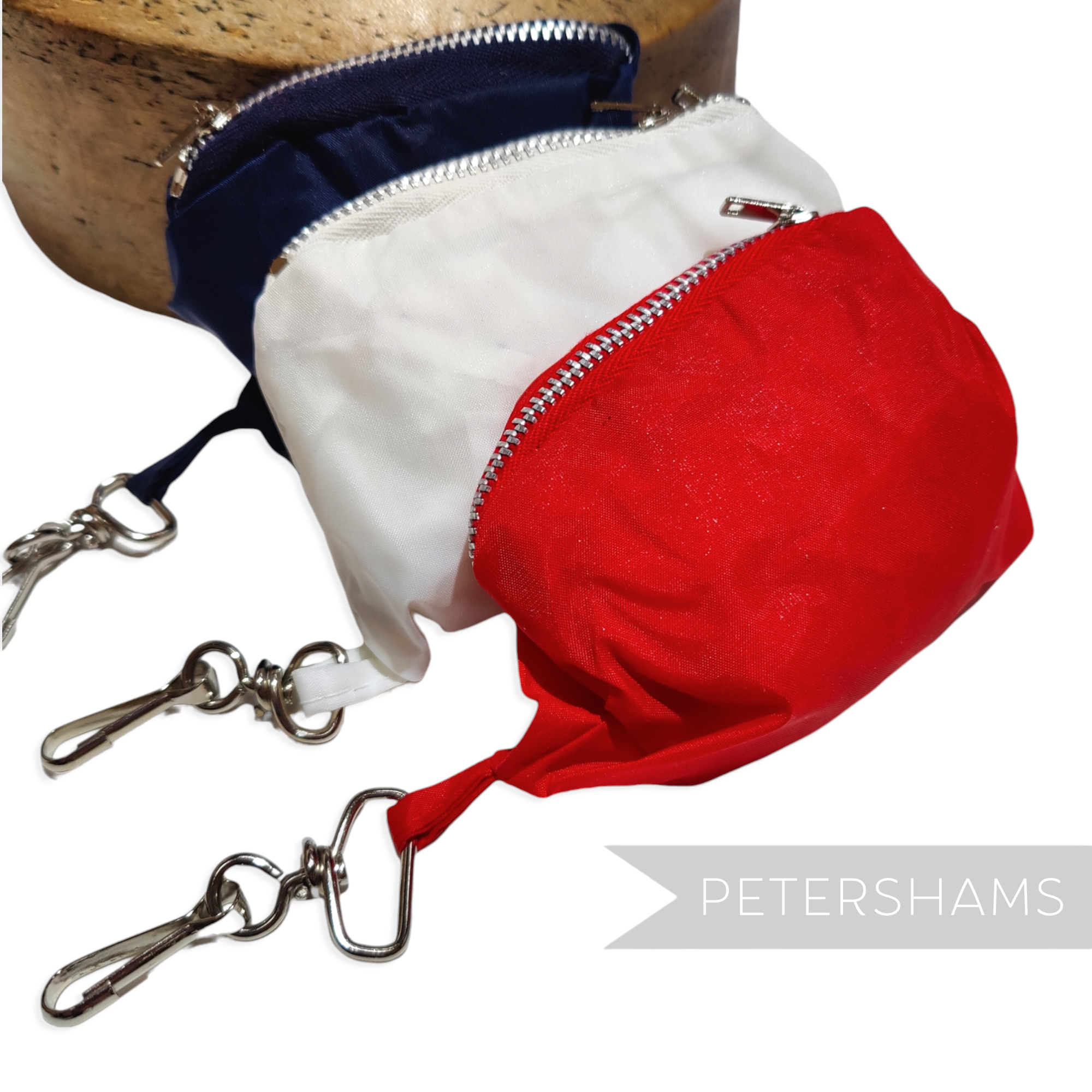 Petershams Millinery Supplies vintage nylon fold-up bucket hats in red, white, and navy with key chain storage bags.