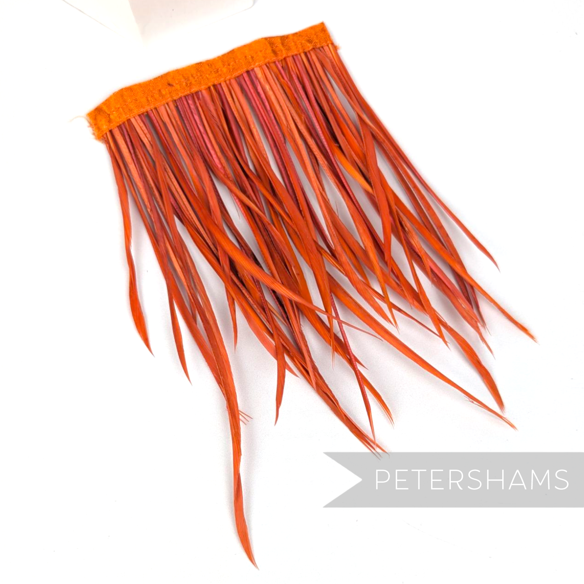 Petershams Millinery Supplies extra long burnt orange goose biot feather fringe on a stitched satin ribbon binding