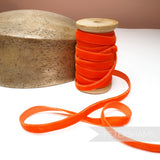 Petershams Millinery Supplies 10mm vintage orange rayon velvet ribbon on a wooden spool next to a millinery block