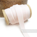Petershams Millinery Supplies 16mm pale pink elastic stretch velvet ribbon on a wooden spool for millinery projects.