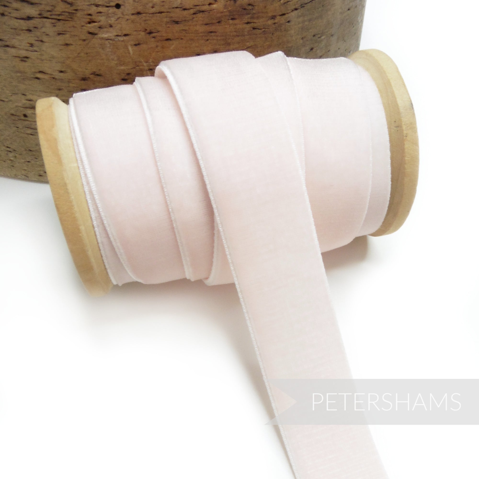 Petershams Millinery Supplies 23mm pale pink elastic stretch velvet ribbon on a wooden spool