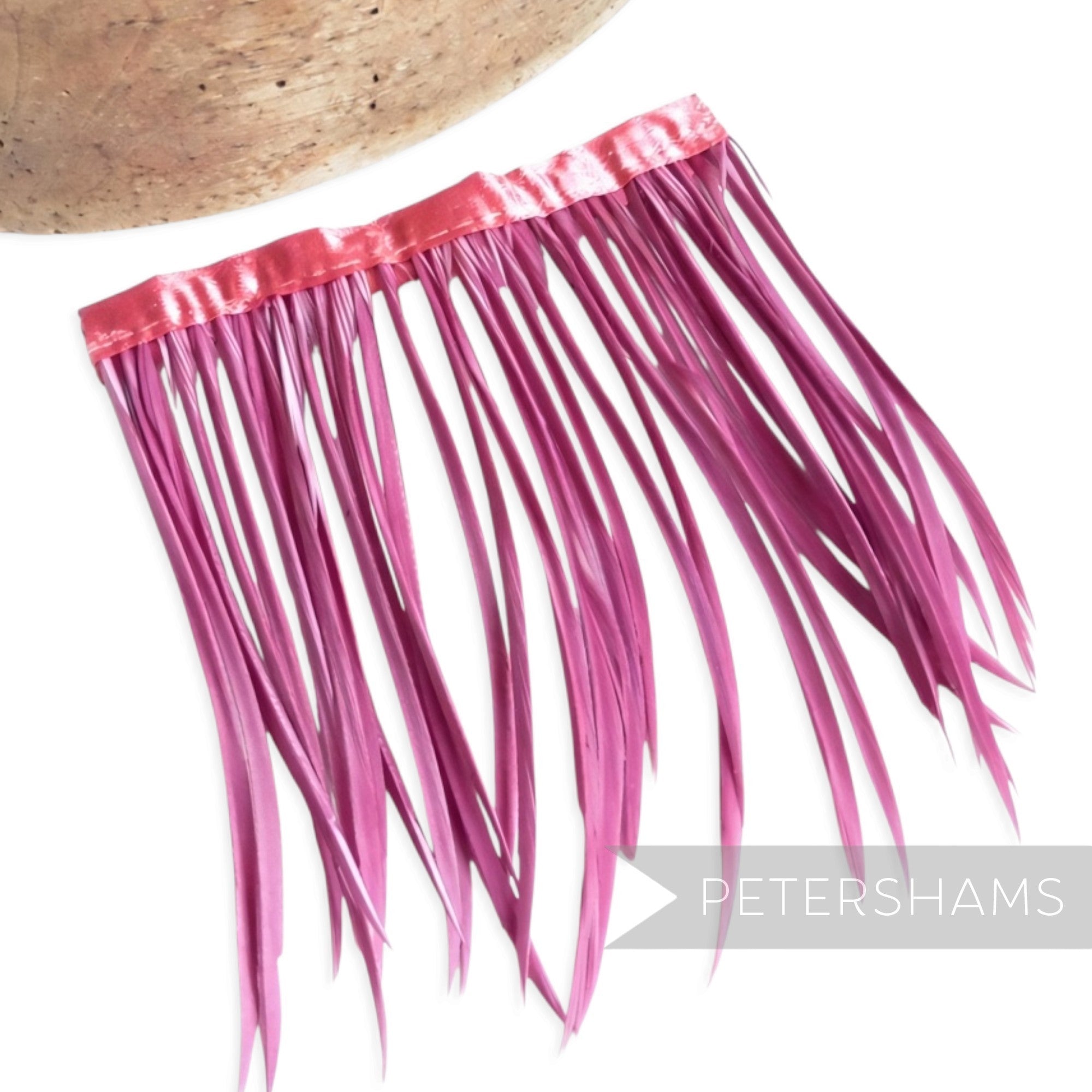 Petershams Millinery Supplies goose biot feather fringe in vibrant pink with a matching satin ribbon binding.