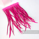 Petershams Millinery Supplies extra long neon pink goose biot feather fringe on a stitched satin ribbon binding.