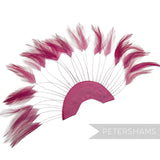 Petershams Millinery Supplies cerise stripped hackle feather fan on a half-circle cotton base for hat trimming.