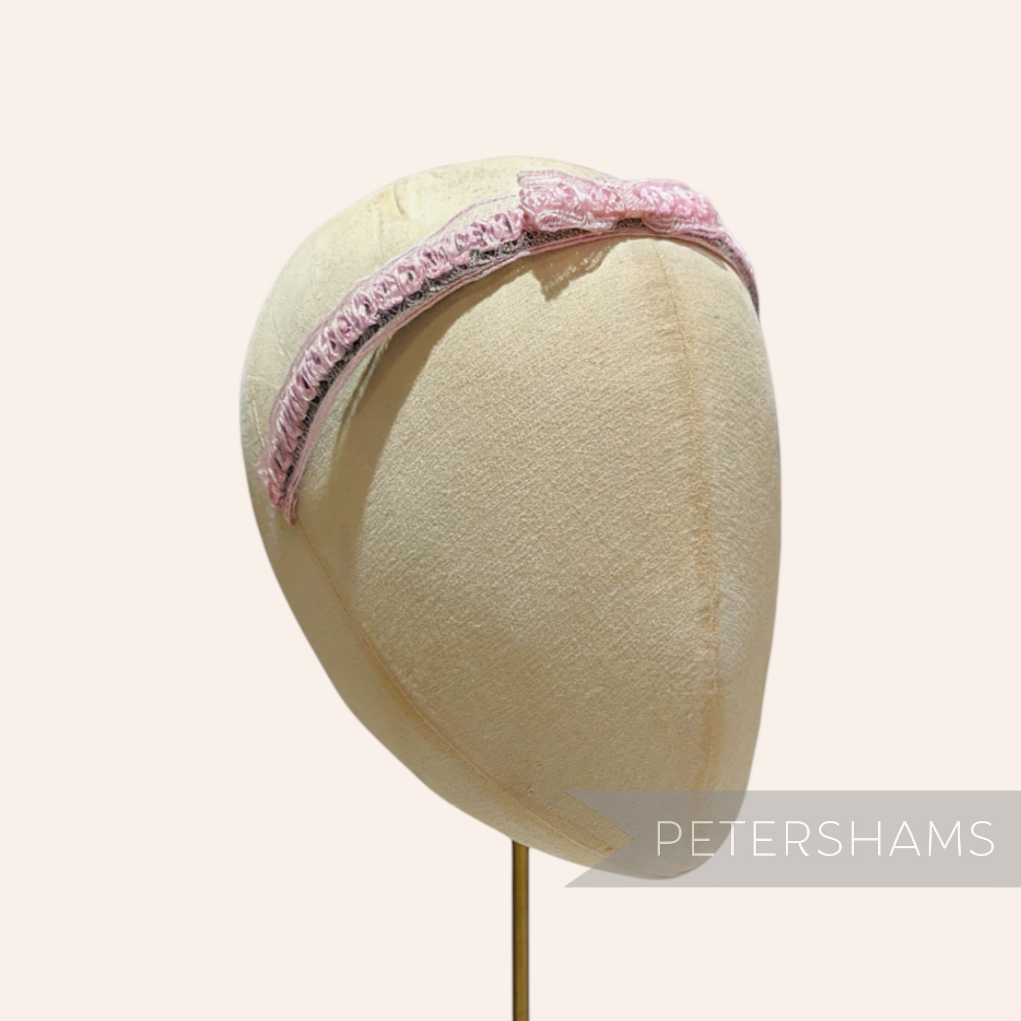 Petershams Millinery Supplies pink laminated raffia and crin braid headband with a small bow, 1960s style.
