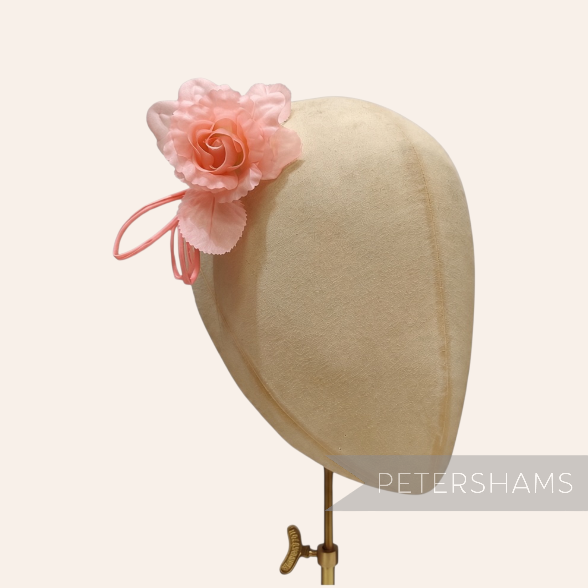 Petershams Millinery Supplies Zahra petite pink silk flower hat mount with wired leaves on a millinery head block