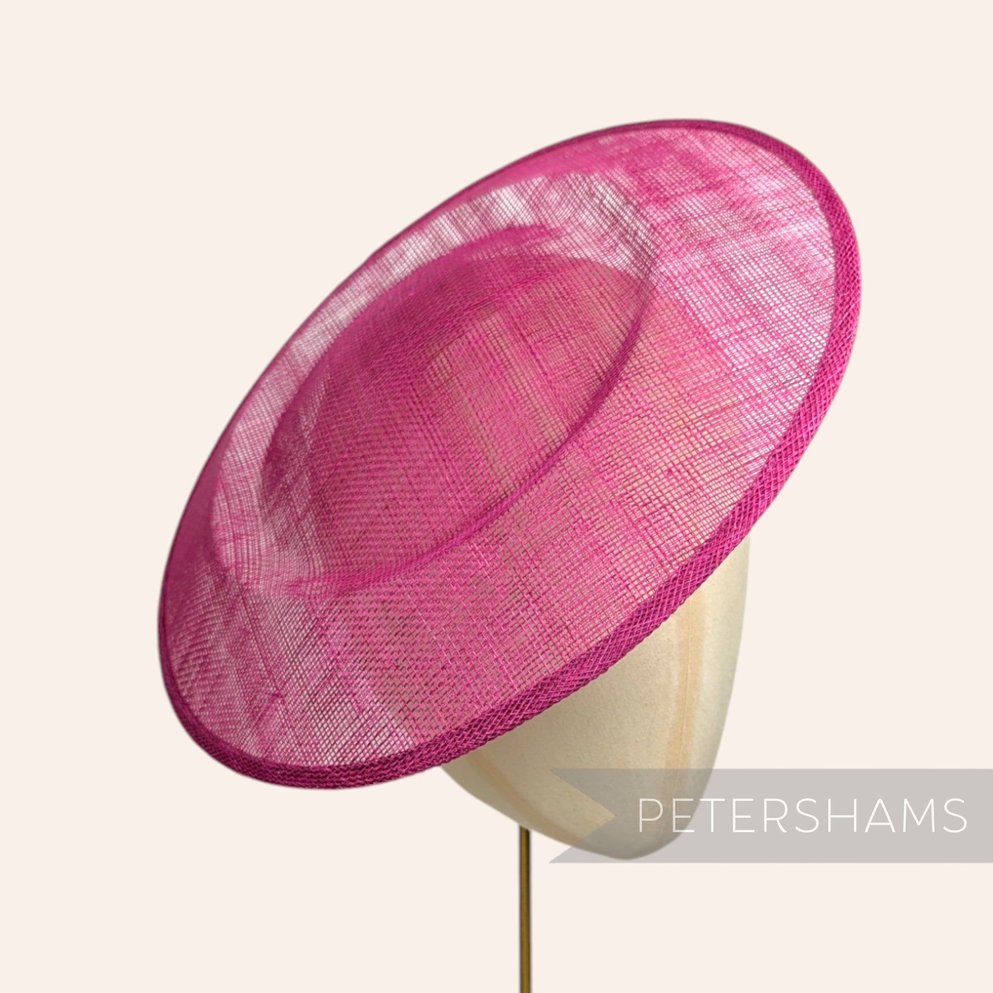 Petershams Millinery Supplies large round cerise pink sinamay fascinator hat base on a millinery head form.