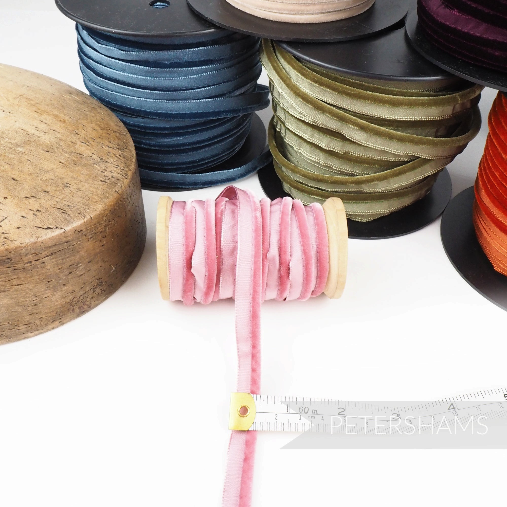 Petershams Millinery Supplies 5mm pink velvet insertion piping cord on a wooden spool with measuring tape