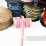 Petershams Millinery Supplies 5mm pink velvet insertion piping cord on a wooden spool with measuring tape