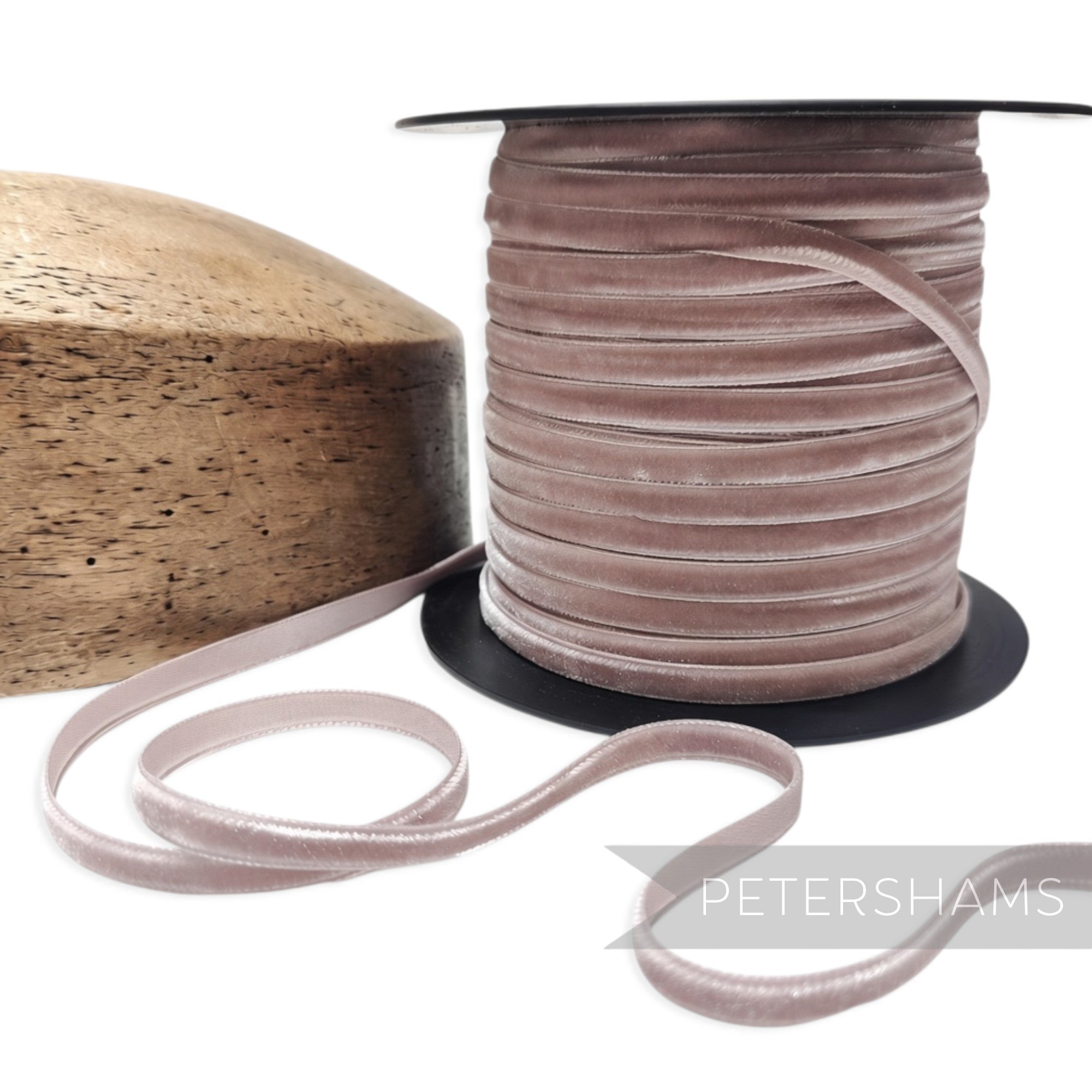 Petershams Millinery Supplies 7mm dusty pink French velvet ribbon on a spool next to a wooden millinery block