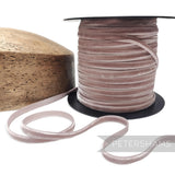 Petershams Millinery Supplies 7mm dusty pink French velvet ribbon on a spool next to a wooden millinery block