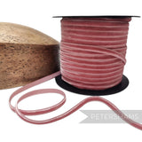 Petershams Millinery Supplies 7mm dusty pink French nylon velvet ribbon on a spool next to a wooden hat block
