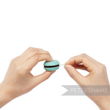 Petershams Millinery Supplies pistachio green macaron needle minder and sharpener being used to sharpen a needle