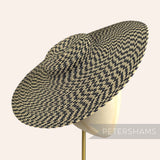 Petershams Millinery Supplies polybraid cartwheel fascinator hat base in a black and natural woven spiral pattern.
