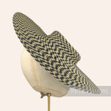 Petershams Millinery Supplies polybraid cartwheel fascinator hat base in a black and beige geometric spiral pattern.