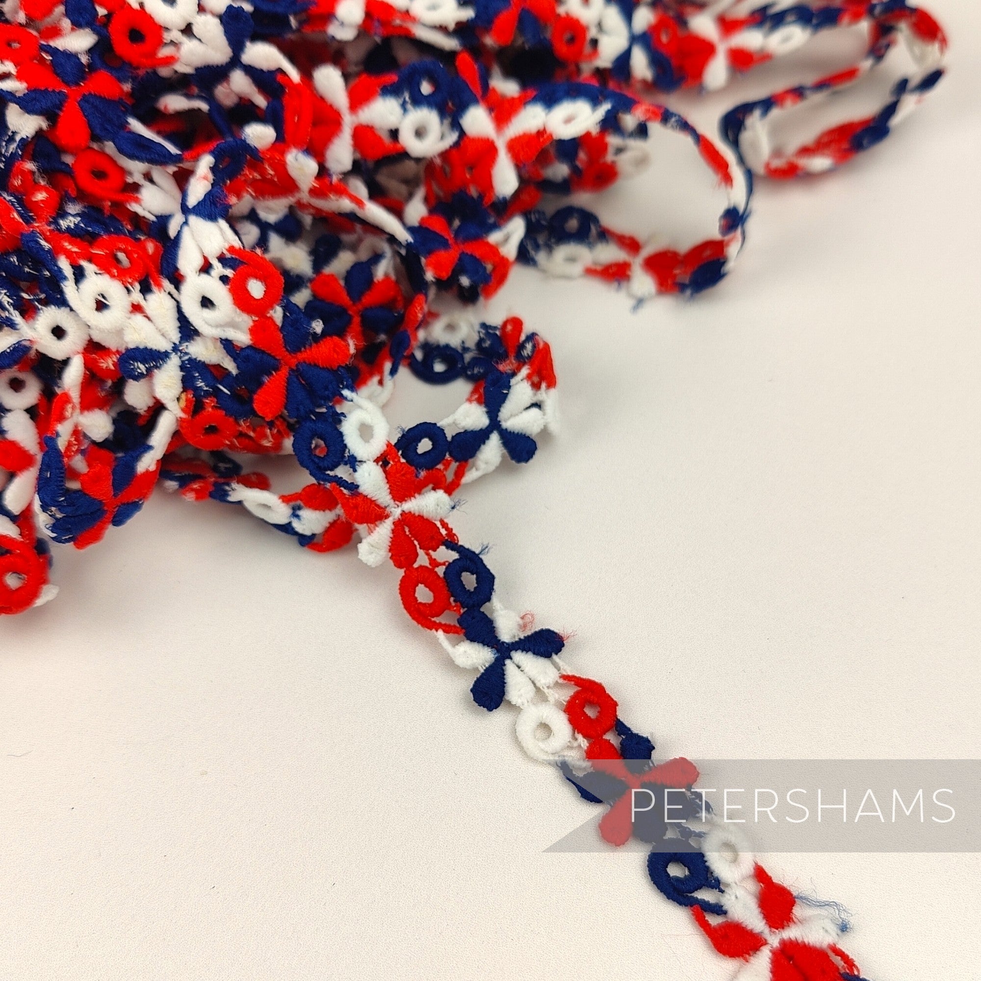 Petershams Millinery Supplies vintage 1960s 15mm red white and blue psychedelic flower guipure lace trim