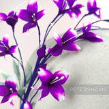 Petershams Millinery Supplies vintage 1980s purple blossom spray with white-tipped petals and green leaves