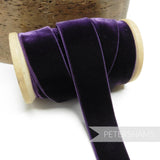Petershams Millinery Supplies 23mm deep purple elasticated velvet ribbon on a wooden spool for millinery projects.