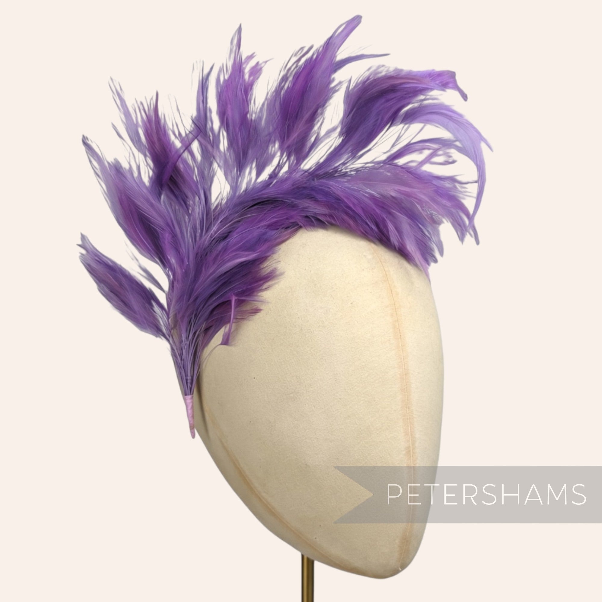 Petershams Millinery Supplies large purple stripped hackle feather mount on a wired stem displayed on a hat block