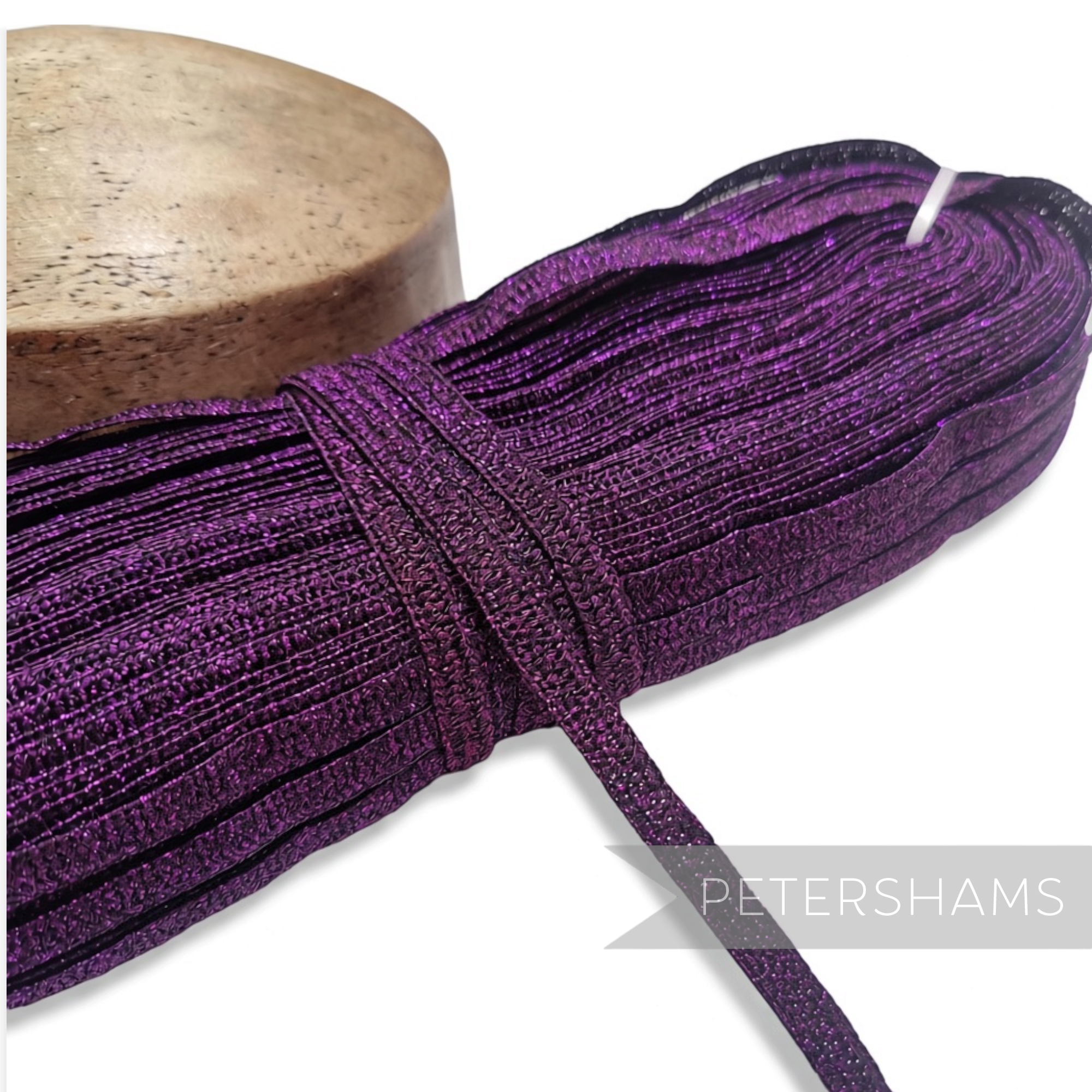 Petershams Millinery Supplies 10mm purple sparkly lurex crinoline hat braid hank with a raised zig-zag texture.