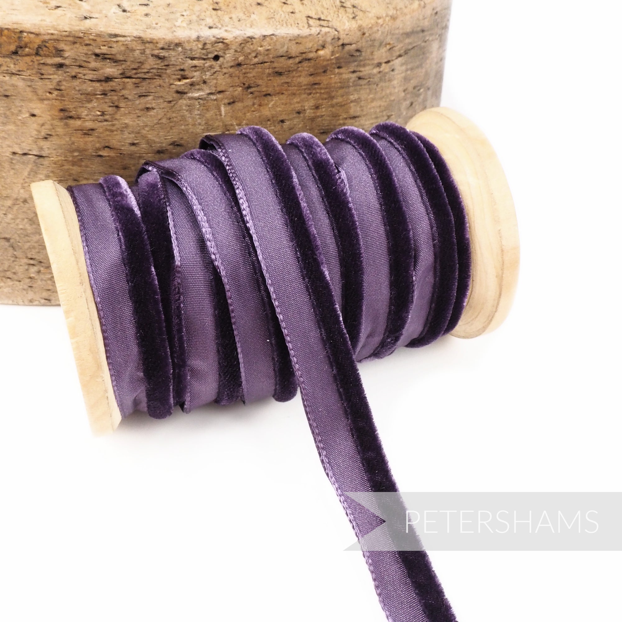 Petershams Millinery Supplies 5mm deep purple velvet insertion piping cord on a wooden spool for sewing and millinery.