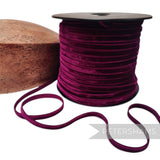 Petershams Millinery Supplies 7mm deep purple French velvet ribbon on a spool next to a wooden millinery block