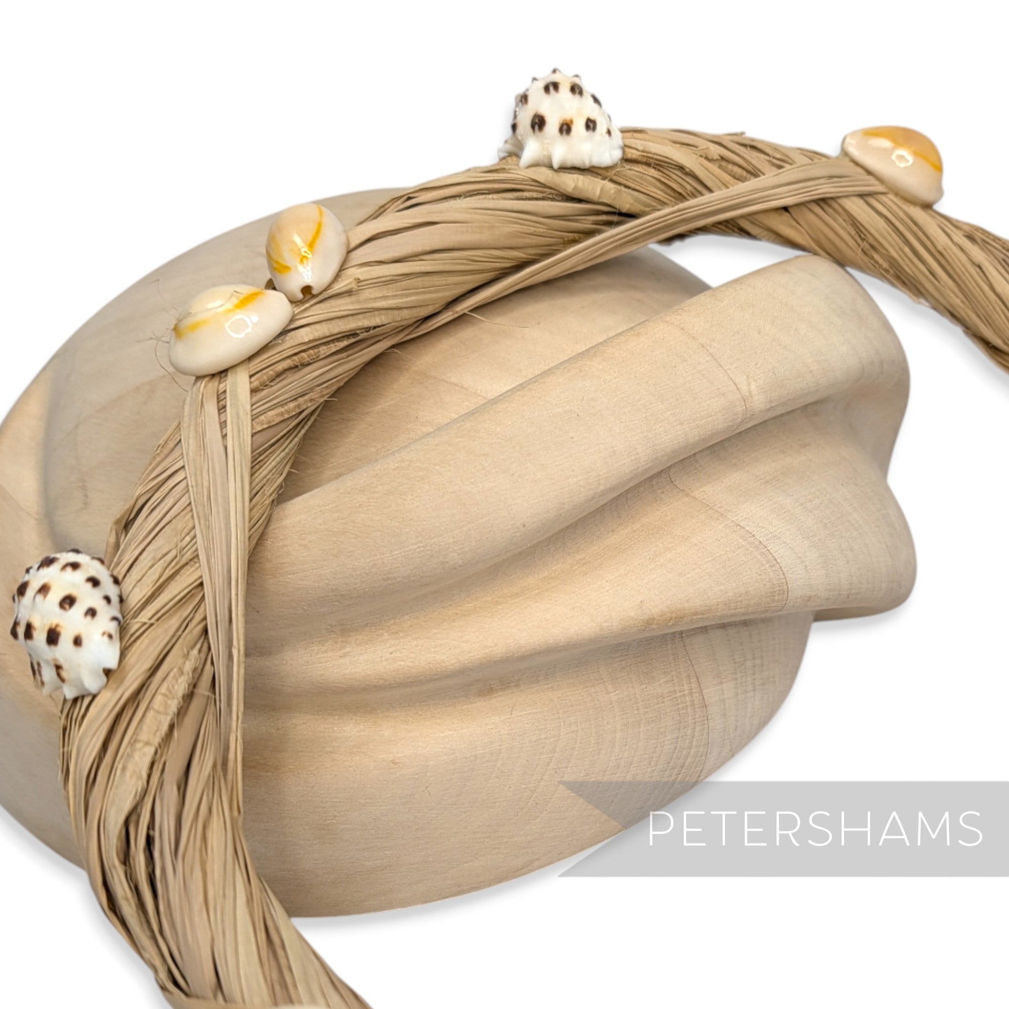 Petershams Millinery Supplies natural raffia headdress frame adorned with assorted seashells.