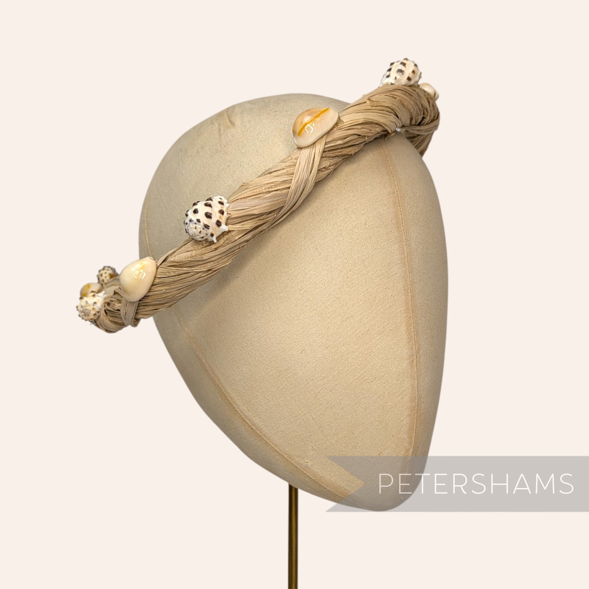 Petershams Millinery Supplies natural raffia headdress frame adorned with assorted seashells.