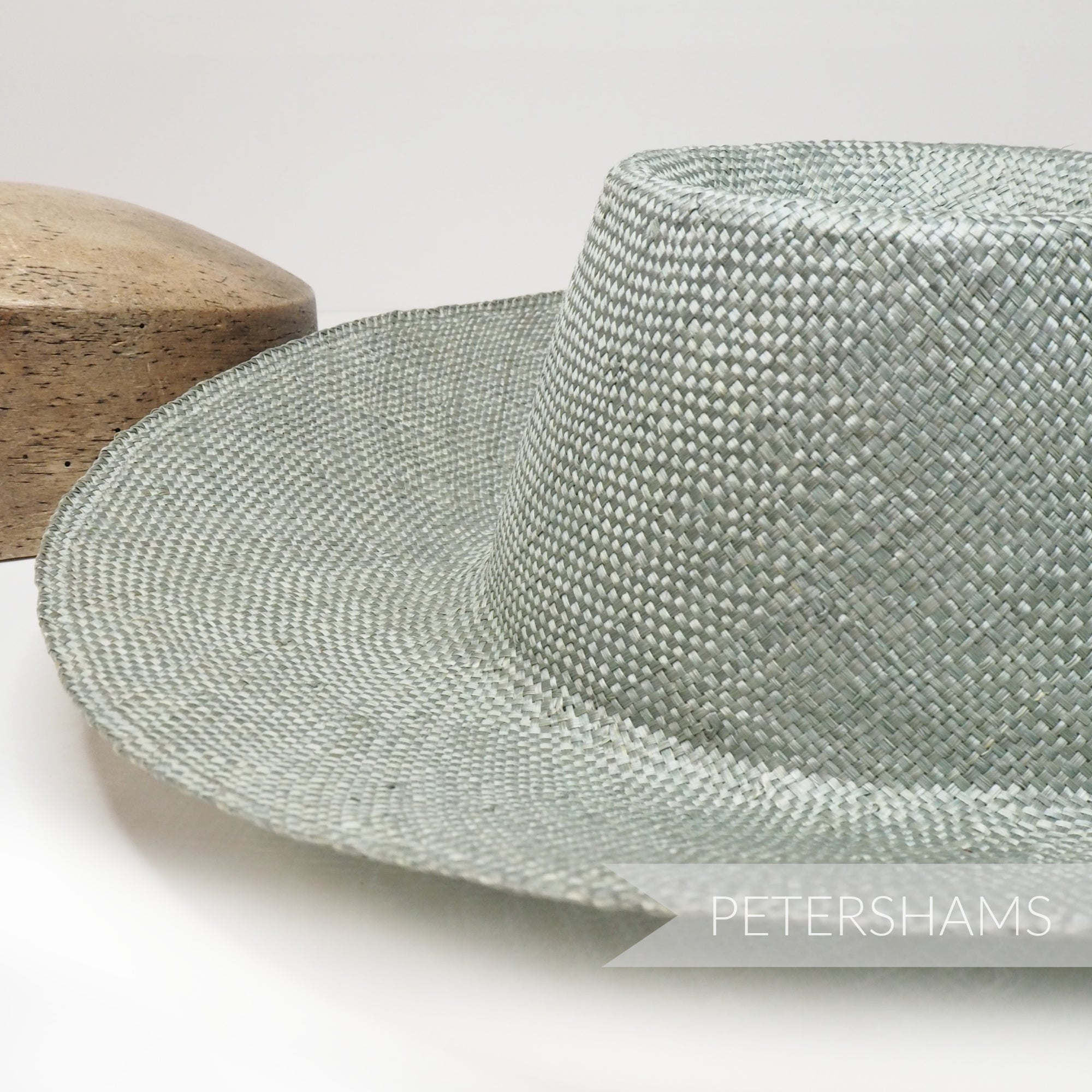Petershams Millinery Supplies ramie straw capeline hat body with a 1x1 checker weave in a smooth pale green finish.