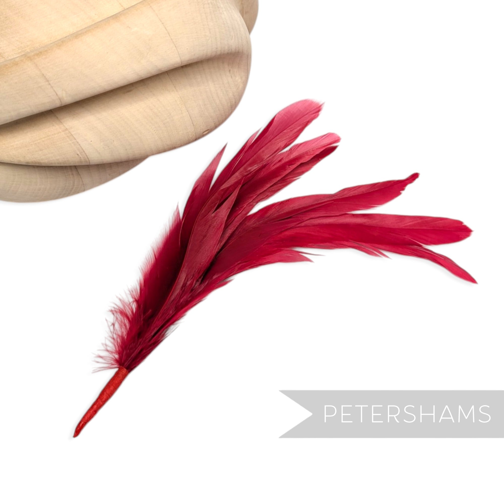 Petershams Millinery Supplies red full coque feather hat mount with six lush feathers on a wired stem.
