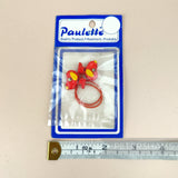 Petershams Millinery Supplies vintage red cartoon dog hair bobble in original packaging with measuring tape