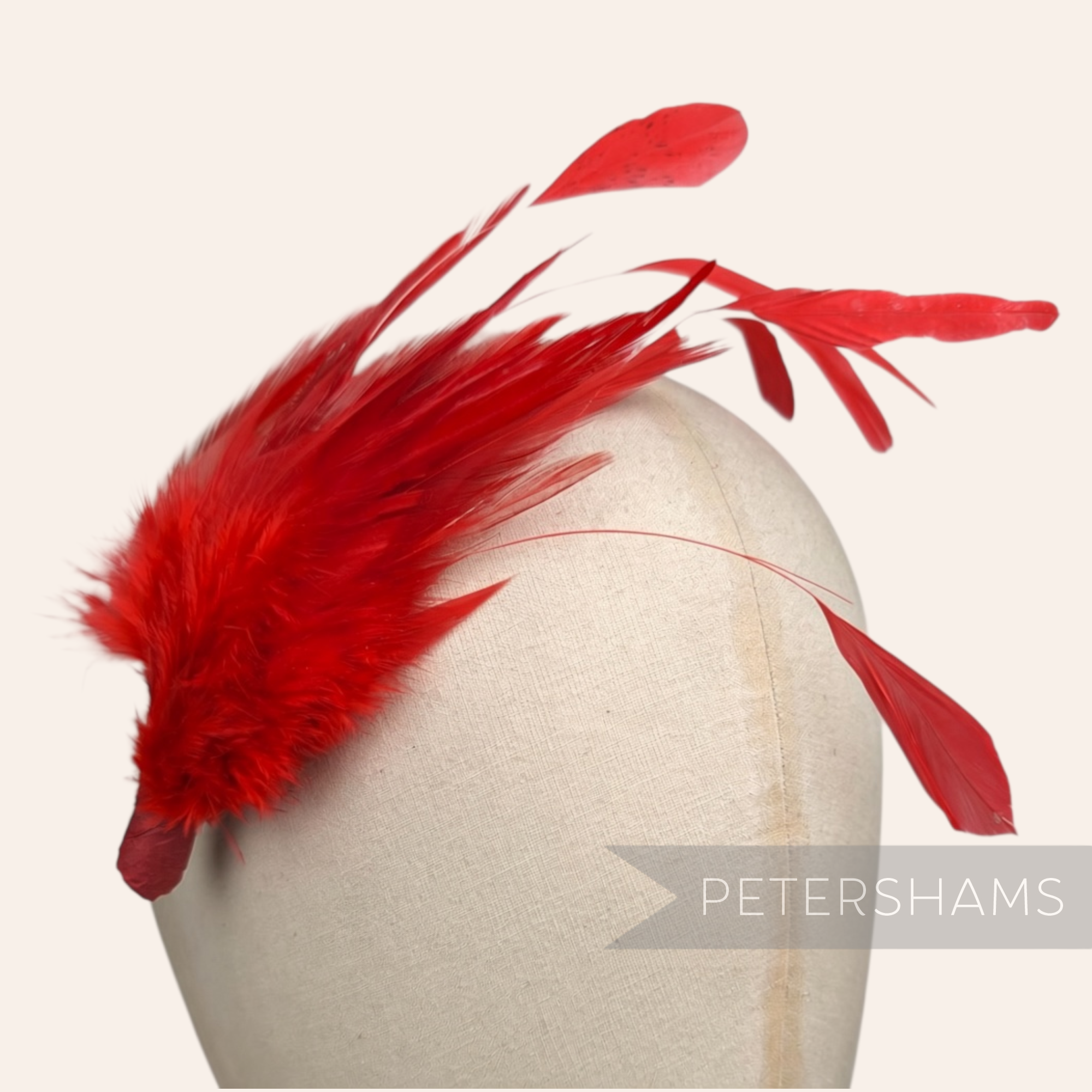 Petershams Millinery Supplies vibrant red feather hat mount featuring soft hackle and stripped coque feathers.