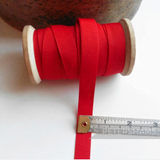 Petershams Millinery Supplies vintage 15mm wide red grosgrain ribbon on a wooden spool with a measuring tape.