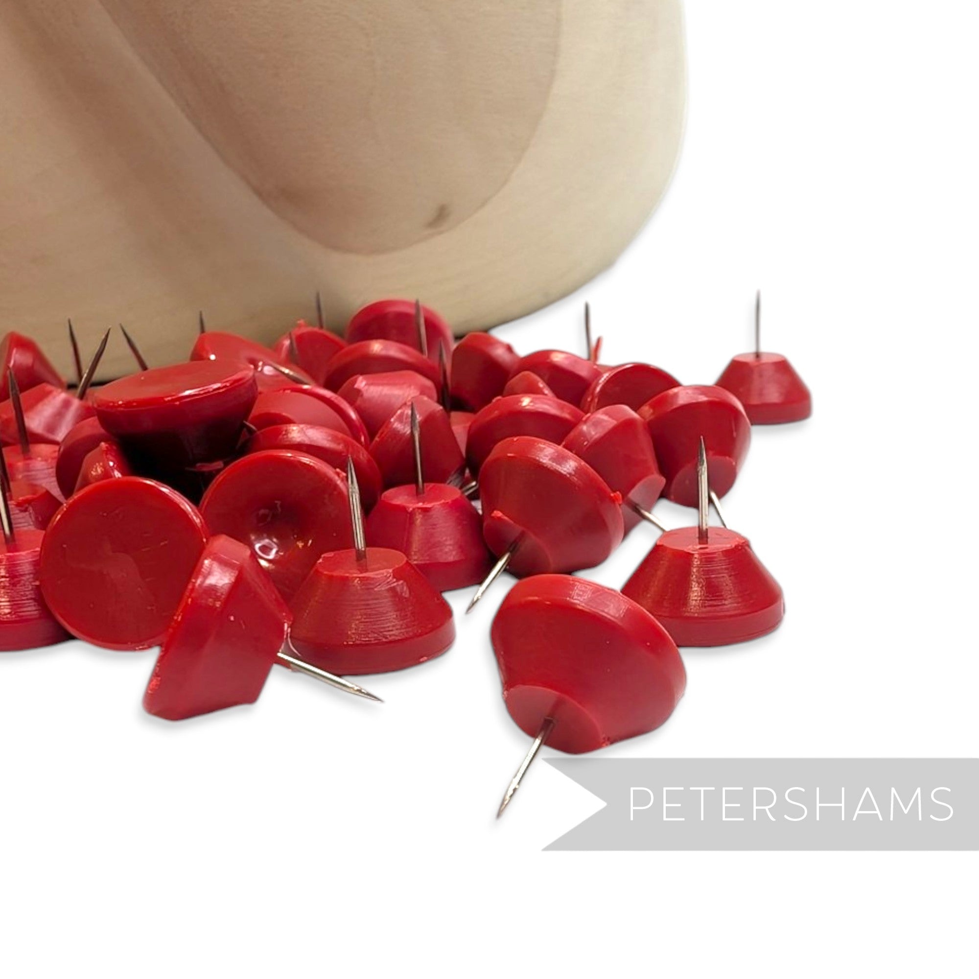 Petershams Millinery Supplies red hat blocking pins with dome-shaped tops and sharp metal tips for millinery work