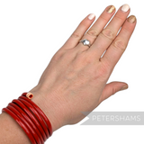 Petershams Millinery Supplies vintage 1940s red plastic tube wrap bracelet worn on a wrist